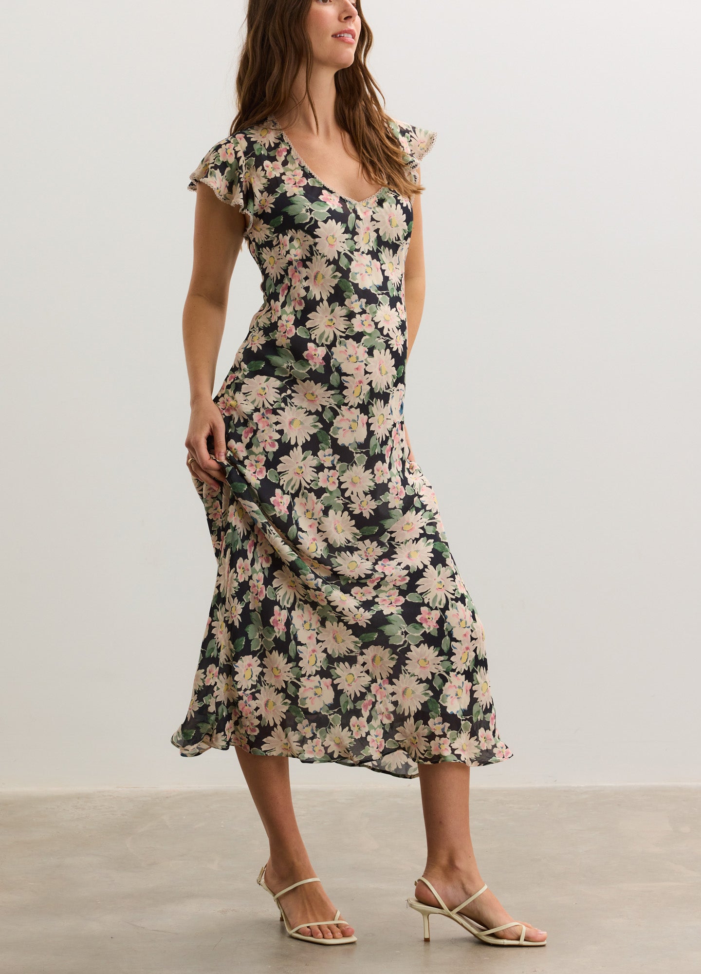 Floral midi maternity dress with short flutter sleeves and fitted empire waist in soft fabric.
